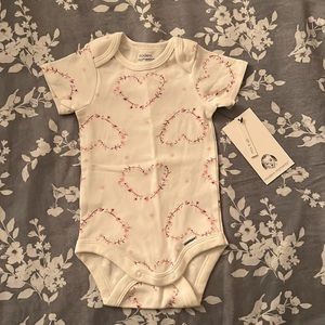 Onesie 0-3 months white pink and red flowers around hearts print.